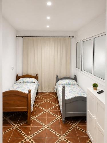 a bedroom with two beds in a room at STUDIO FOR 3 PERSON & ANOTHER FOR 4 PERSON - MIRAMAR MARTIL ll in Martil