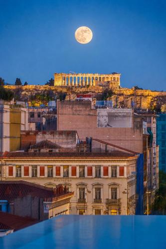 a view of a building with a moon in the sky at VISION Omonia Athens in Athens