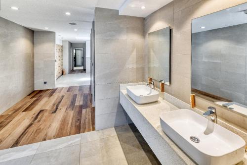 a bathroom with a sink and a mirror at Spacious 2-Bedroom Family Suite with Pool & Garden View in Moka
