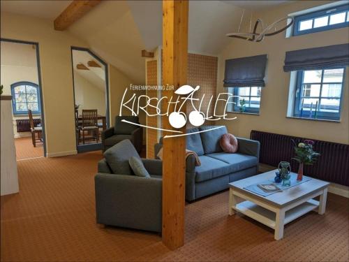 a living room with two couches and a table at Ferienwohnung Zur Kirschallee in Hochkirch