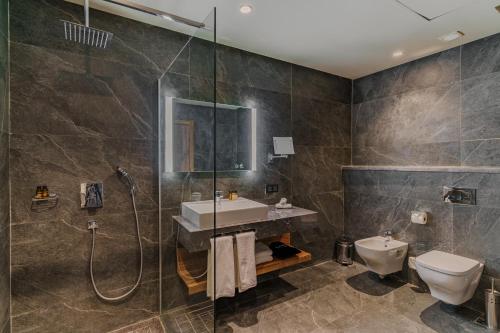 a bathroom with a shower and a sink and a toilet at Grand Dominium in Agadir