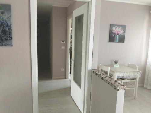 a hallway with a door and a table in a room at Villa Rosetta relax in Scrutto