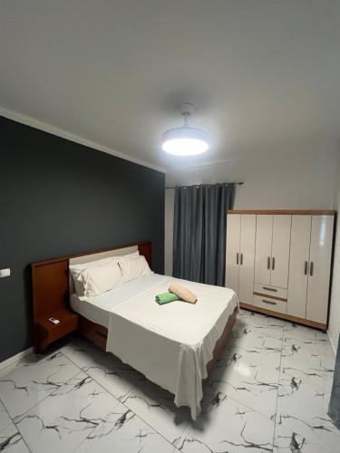 a bedroom with a bed and a light on the ceiling at Apartamentos Santiago - Praia in Praia