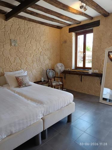 a bedroom with a bed and a window at Gîte Chevannes - Holiday home - Pool - Parking - Mobility friendly - Pets welcome in Fours