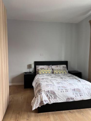 a bedroom with a bed and two night stands at Cheerful cottage 3-bedroom in Drehidnaraga Bridge