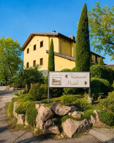 a sign in a garden in front of a building at Hotel Ristorante Vecchia Riva in Varese