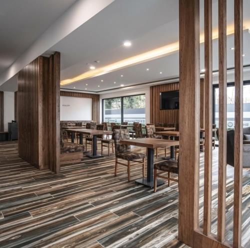 a conference room with tables and chairs and a projection screen at Zenith Hotel Frankfurt Airport in Kelsterbach