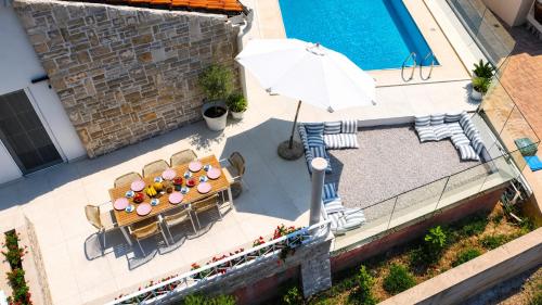 an overhead view of a table and chairs and an umbrella at Orebic Luxury Villa Leopold in Orebić
