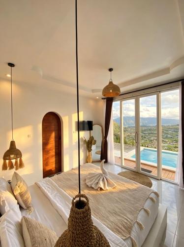 ein Schlafzimmer mit einem großen Bett und einem großen Fenster in der Unterkunft Hidden Hill in Gretek