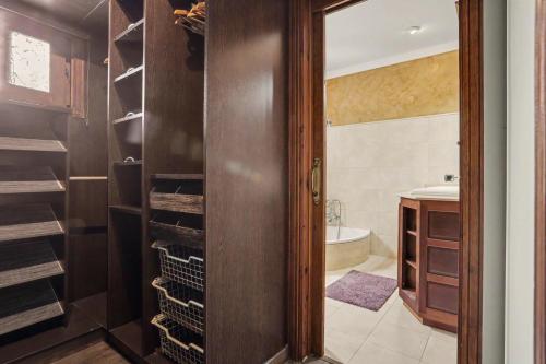 a bathroom with a closet with a sink and a tub at Rincón de Daute in Los Silos