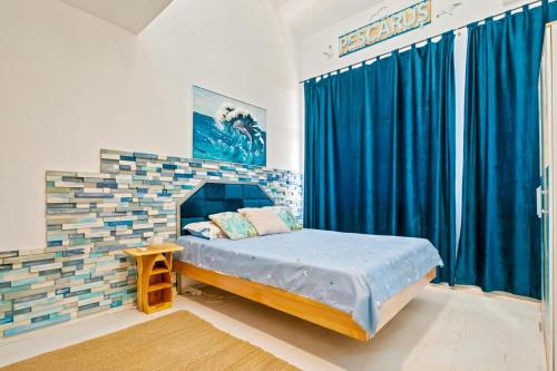 a bedroom with a bed in a room with blue curtains at Apartament Pescăruș in Schitul
