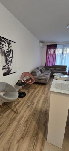 a living room with a couch and a table at Flat Rafailovic One minute to Beach in Budva