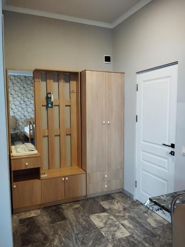 a room with wooden cabinets and a white door at The Corner Hotel in Yerevan