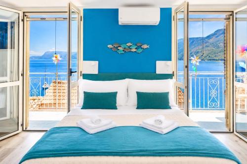 a bedroom with a large bed with blue walls at Chianalea Guesthouse in Scilla
