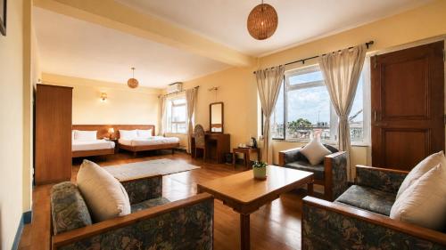 a living room with a couch and a table at Hotel Sherwi Hyul in Kathmandu