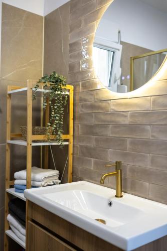 a bathroom with a sink and a mirror at Dimitra Beach Apartments - Thassos Skala Potamias in Skala Potamias