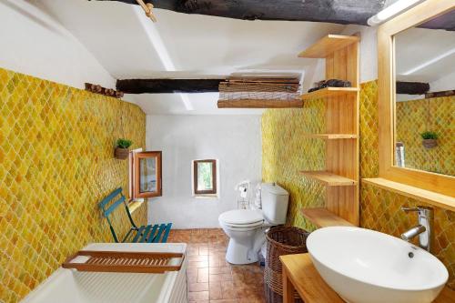a bathroom with a white sink and a toilet at La Clé de l'Arboux in Mandagout