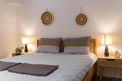 a bedroom with a bed with two lamps and two tables at Dimitra Beach Apartments - Thassos Skala Potamias in Skala Potamias