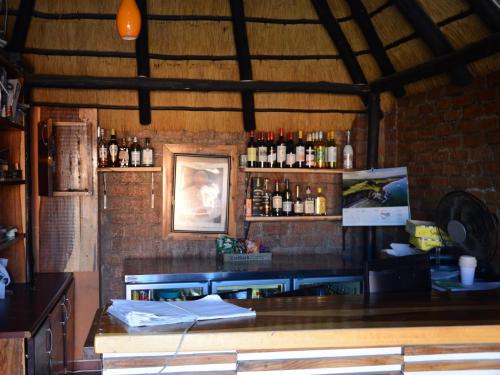 a bar in a restaurant with a brick wall at Oluzizi Guesthouse in Windhoek