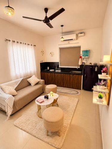 a living room with a couch and a flat screen tv at BNBees Anjuna Goa in Chapora