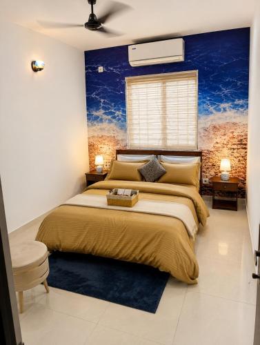 a bedroom with a large bed with a blue wall at BNBees Anjuna Goa in Chapora