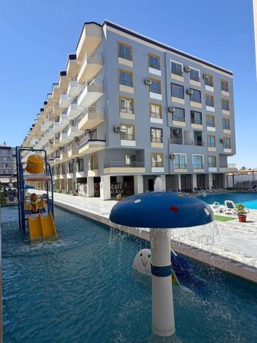 a large building with a water park in front of it at Lavanda Beach Resort Studio - Panoramic Sea & Pool View in Abū Rudays