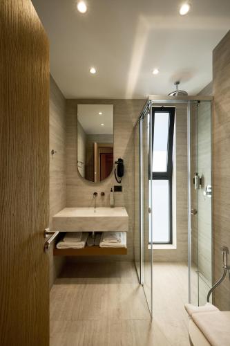 a bathroom with a sink and a shower at Veranda Hotel by Mirage in Ksamil