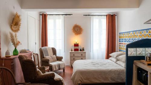 a bedroom with a bed and a chair and a dresser at Studio Agave in Correns
