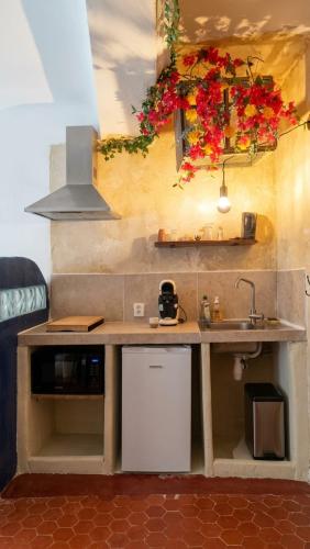 a kitchen with a counter with a sink and flowers at Studio Agave in Correns