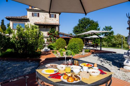a table with food on top of a patio at B&B Villa Cardeto in Anghiari