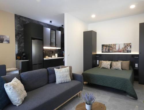 a living room with a couch and a bed at Estación 87 Smart Workation y Relax Mediterráneo in Peniscola