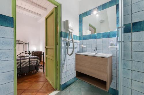 a bathroom with a sink and a shower at Case Saponara in Cefalù