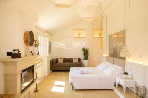 a living room with a white couch and a fireplace at Masseria Bandino & Spa in Otranto