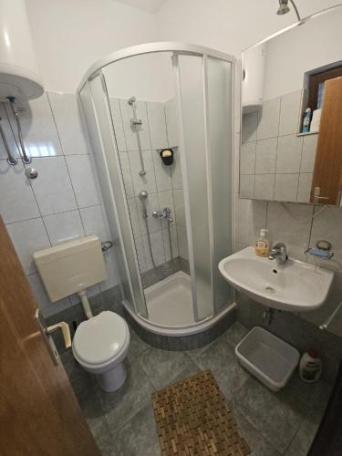 a bathroom with a shower and a toilet and a sink at See view Apartment 2 in Mimice