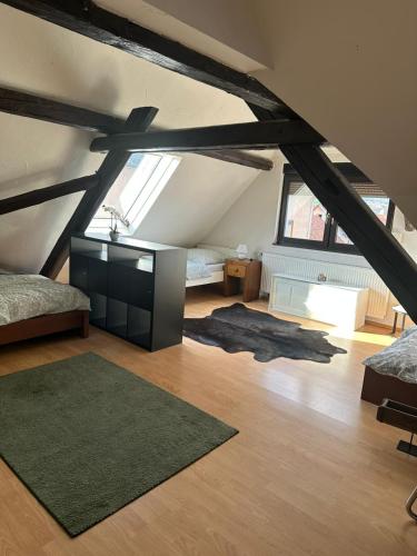 a room with a loft with a bed and a rug at Landhaus Butzbach in Butzbach