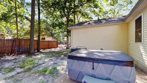 a bath tub sitting outside of a house at Piney Glade - 18628 Sylvan Dr in Rehoboth Beach