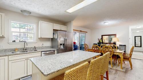 a kitchen and dining room with a table and chairs at Piney Glade - 18628 Sylvan Dr in Rehoboth Beach