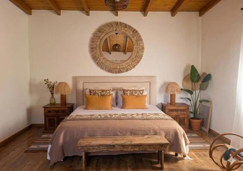 a bedroom with a bed with a mirror on the wall at El Refugio de la Caridad in Tenteniguada