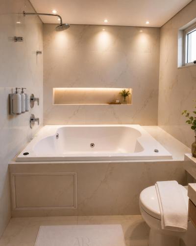 a white bathroom with a tub and a toilet at Hotel Arujá in Arujá