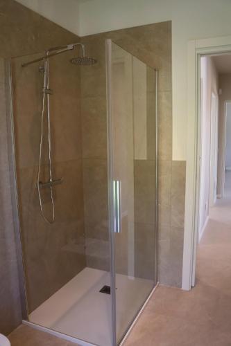 a shower with a glass door in a bathroom at Villa Grace in Padenghe sul Garda