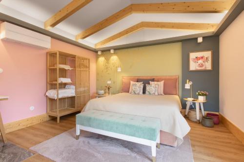 a bedroom with a large bed and wooden ceilings at d'Olívia Lovely Homes in Cela
