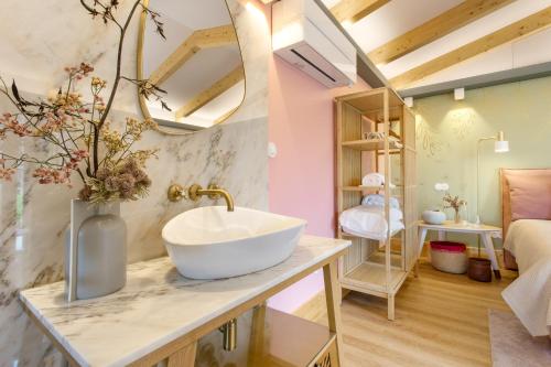 a bathroom with a sink on a counter in a room at d'Olívia Lovely Homes in Cela