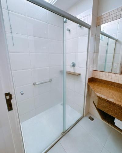 a shower with a glass door in a bathroom at Ubatuba Palace Hotel in Ubatuba