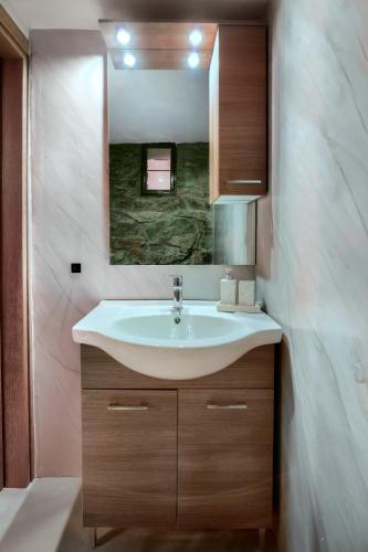 a bathroom with a sink and a mirror at Saronic Citadel Luxury Villa-Private Estate on Salamina Island in Salamina