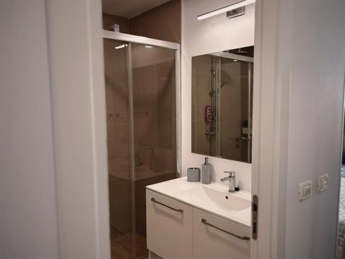 a white bathroom with a sink and a shower at Studio Privat Reea Olimp in Olimp