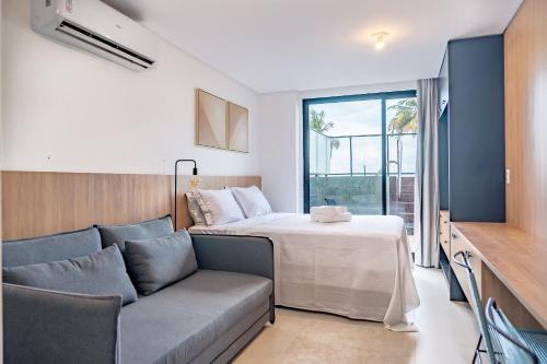 a living room with a bed and a couch at Sun Smart por Quarto a Vista in Ilha da Restinga
