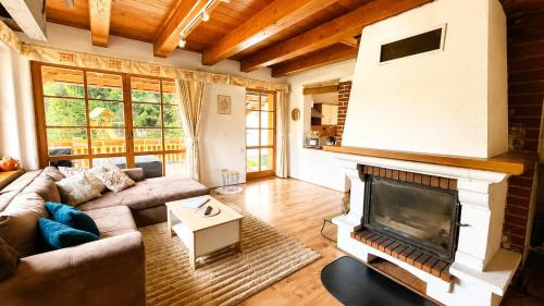 a living room with a couch and a fireplace at Chalupa u rybníčku in Doksy