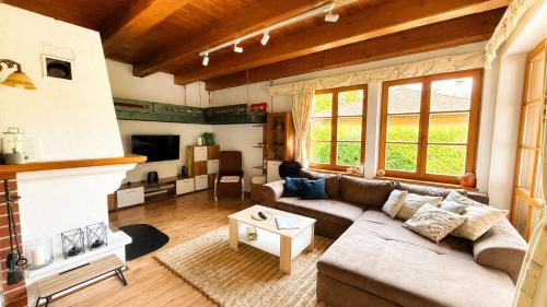 a living room with a couch and a fireplace at Chalupa u rybníčku in Doksy