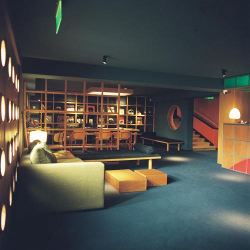 a living room with a couch and a table at Blueberry Nights in Tbilisi City
