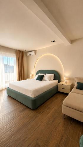 a bedroom with a large bed and a window at Donna in Ulcinj